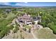 Stunning aerial view of a luxury home with mature landscaping and mountain views at 2916 Hiwall Ct, Castle Rock, CO 80109