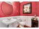 Charming powder room featuring classic fixtures, bird-themed wallpaper, and elegant wainscoting at 2916 Hiwall Ct, Castle Rock, CO 80109