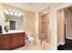 Neutral bathroom featuring a glass-enclosed shower, cherry vanity and ceramic tile flooring at 2916 Hiwall Ct, Castle Rock, CO 80109