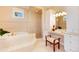 Bright bathroom featuring a soaking tub with jets, glass shower, vanity, and tile floor at 2916 Hiwall Ct, Castle Rock, CO 80109