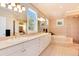 Luxurious bathroom featuring double vanities, a soaking tub, and a glass-enclosed shower at 2916 Hiwall Ct, Castle Rock, CO 80109