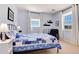 Comfortable blue bedroom with two windows and patterned bedding at 2916 Hiwall Ct, Castle Rock, CO 80109