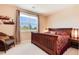 Bedroom featuring a large window, a comfortable bed, and stylish furniture at 2916 Hiwall Ct, Castle Rock, CO 80109
