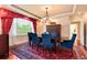 Formal dining room featuring a large window, decorative rug, and stylish chandelier at 2916 Hiwall Ct, Castle Rock, CO 80109