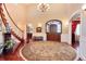 Elegant foyer featuring a grand staircase, hardwood floors, and a decorative rug at 2916 Hiwall Ct, Castle Rock, CO 80109