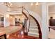 Bright foyer with a curved staircase and views into the living spaces at 2916 Hiwall Ct, Castle Rock, CO 80109