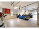 Large garage with epoxy flooring, an American flag, and garage door openers at 2916 Hiwall Ct, Castle Rock, CO 80109