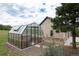 Well-placed greenhouse next to the main property surrounded by mature trees and vegetation at 2916 Hiwall Ct, Castle Rock, CO 80109