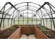 Interior view of a well-lit greenhouse with raised garden beds and automated ventilation system at 2916 Hiwall Ct, Castle Rock, CO 80109