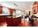 Spacious kitchen featuring a large island, custom cabinets, and hardwood floors at 2916 Hiwall Ct, Castle Rock, CO 80109