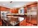 Gourmet kitchen with custom cabinetry, granite countertops, and stainless steel appliances at 2916 Hiwall Ct, Castle Rock, CO 80109