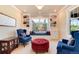 Cozy living room with a window seat, custom shelves, and comfortable armchairs at 2916 Hiwall Ct, Castle Rock, CO 80109