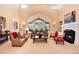 Elegant living room with tall ceilings, large windows, and a cozy fireplace at 2916 Hiwall Ct, Castle Rock, CO 80109