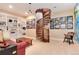 Comfortable living area with a spiral staircase, custom bookshelves, and unique decorative touches at 2916 Hiwall Ct, Castle Rock, CO 80109