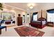 Elegant main bedroom featuring a four-poster bed, sitting area, and large windows for natural light at 2916 Hiwall Ct, Castle Rock, CO 80109