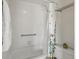 Bathroom featuring a tub with shower, tiled walls, and a convenient grab bar at 277 S Taft Ct # 54, Louisville, CO 80027