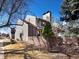 Charming exterior side view of the home featuring a fenced yard with well-maintained landscaping at 277 S Taft Ct # 54, Louisville, CO 80027