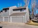 Exterior of gray home featuring an attached garage and a manicured lawn with a blue sky at 277 S Taft Ct # 54, Louisville, CO 80027