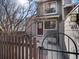 Inviting front entrance featuring a red door, metal fence, and a small porch area at 277 S Taft Ct # 54, Louisville, CO 80027