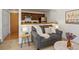 Comfortable living room featuring a gray sofa, side table, and a partial view of the kitchen at 277 S Taft Ct # 54, Louisville, CO 80027