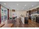 Stylish kitchen and dining area with stainless steel appliances, dark wood cabinetry, and a sliding door at 2936 Iola St, Denver, CO 80238