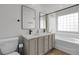 Stylish bathroom features a double vanity, modern mirrors, and a shower/tub combo at 1409 Carlyle Park Cir, Highlands Ranch, CO 80129