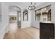 Bright dining room with wood floors, archways, and modern chandelier at 1409 Carlyle Park Cir, Highlands Ranch, CO 80129