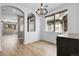 Bright dining room with wood floors, archways, and modern chandelier at 1409 Carlyle Park Cir, Highlands Ranch, CO 80129