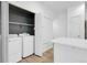 Bright laundry room with modern washer and dryer; ample shelf and storage space included at 1409 Carlyle Park Cir, Highlands Ranch, CO 80129