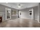 Bright living room featuring wood floors, a fireplace, and large windows with ample natural light at 1409 Carlyle Park Cir, Highlands Ranch, CO 80129