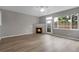 Spacious living room featuring a cozy fireplace and a door to the backyard at 1409 Carlyle Park Cir, Highlands Ranch, CO 80129