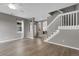 Open-concept living room with staircase and archway details at 1409 Carlyle Park Cir, Highlands Ranch, CO 80129