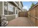 Private patio with brick pavers, a wood fence, and a water feature for outdoor enjoyment at 1409 Carlyle Park Cir, Highlands Ranch, CO 80129
