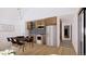 Modern kitchen featuring wooden cabinets, stainless steel appliances, and an open dining area at 733 Turner St, Erie, CO 80516