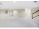 Spacious basement with neutral carpet, bright lighting, and open layout at 6274 S Iola Ct, Englewood, CO 80111