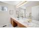 Bathroom featuring a dual sink vanity with a large mirror and tile countertop at 6274 S Iola Ct, Englewood, CO 80111