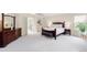 Spacious bedroom boasts a wooden bed frame and a bright window for natural light at 6274 S Iola Ct, Englewood, CO 80111