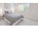 Bright bedroom with a modern patterned bed and bright natural light at 6274 S Iola Ct, Englewood, CO 80111