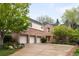 Charming brick home with a three-car garage and mature trees, offering curb appeal and convenience at 6274 S Iola Ct, Englewood, CO 80111