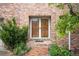Charming brick home featuring a double-door entryway surrounded by beautiful landscaping at 6274 S Iola Ct, Englewood, CO 80111