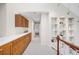 Bright hallway with wooden cabinets and view into the bedroom at 6274 S Iola Ct, Englewood, CO 80111