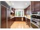 Gourmet kitchen featuring custom cabinets, granite countertops, and stainless steel appliances, perfect for cooking at 6274 S Iola Ct, Englewood, CO 80111