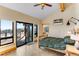 Bedroom with vaulted ceilings, ceiling fan, wood trim, and sliding glass doors to deck at 3535 Eagle Ridge Rd, Longmont, CO 80503