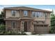 Charming two-story home featuring stone accents, a covered entry, and a two-car garage at 14583 Hudson Way, Thornton, CO 80602