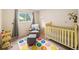 Adorable Bedroom with a crib, comfortable chair, and playful decor at 3756 S Mission Pkwy, Aurora, CO 80013