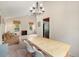 Bright dining area adjacent to the living room with modern light fixture and vaulted ceiling at 3756 S Mission Pkwy, Aurora, CO 80013