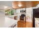 Bright kitchen with stainless steel appliances and a view into an adjacent eating area at 3756 S Mission Pkwy, Aurora, CO 80013