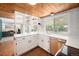Well-lit kitchen features a window over the sink, plus painted brick backsplash and wood ceiling at 3756 S Mission Pkwy, Aurora, CO 80013