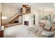 Bright living room with vaulted ceilings, a wood staircase, and an open floor plan at 3756 S Mission Pkwy, Aurora, CO 80013