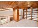 Loft with wood accents and built-in shelves overlooking the living space at 3756 S Mission Pkwy, Aurora, CO 80013